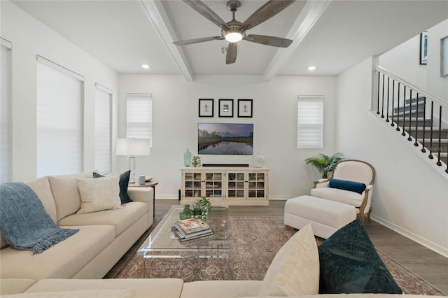 living room featuring stairway, wood finished floors, beam ceiling, and baseboards