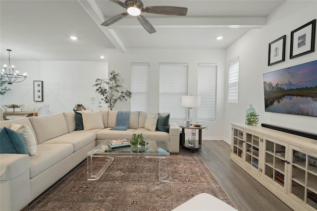 living area featuring ceiling fan with notable chandelier, recessed lighting, beam ceiling, and wood finished floors