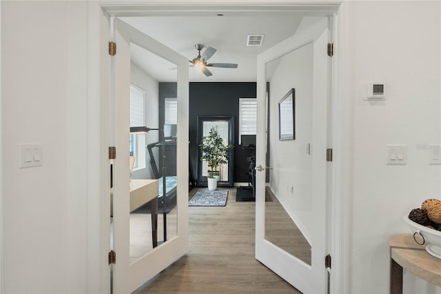 interior space featuring french doors, visible vents, and wood finished floors