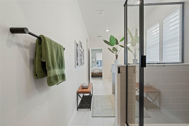 ensuite bathroom featuring a healthy amount of sunlight, a stall shower, ensuite bath, and tile patterned flooring