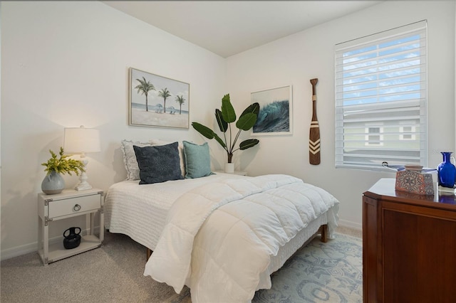 carpeted bedroom featuring baseboards