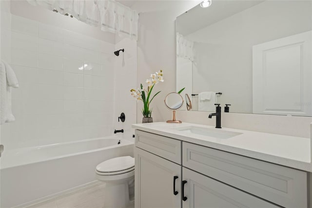 bathroom with washtub / shower combination, vanity, and toilet