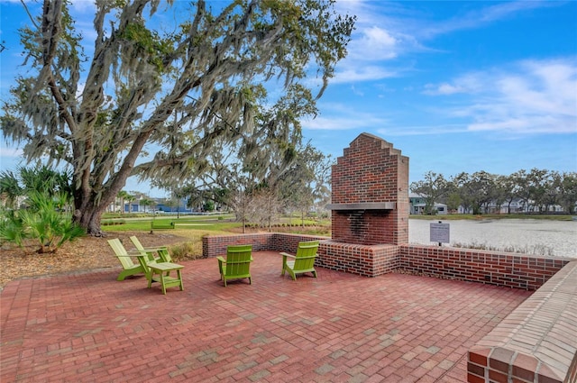 view of patio featuring an outdoor brick fireplace