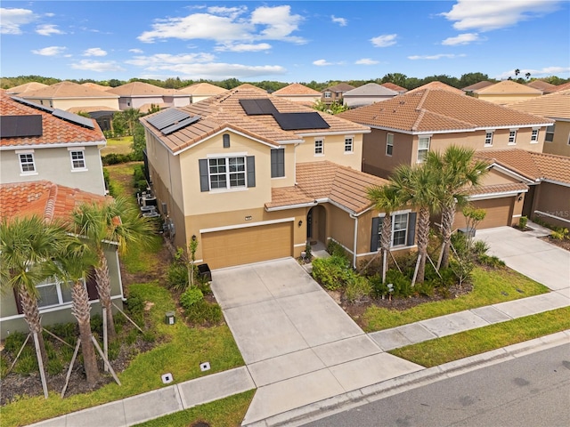 view of front of home featuring stucco siding, driveway, a residential view, and a tiled roof