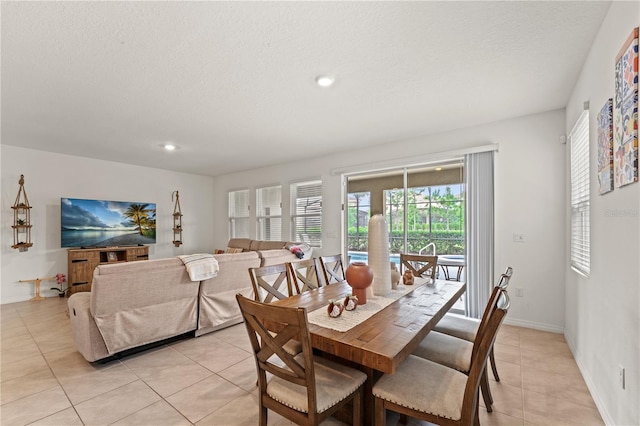 dining area with baseboards, recessed lighting, a textured ceiling, and light tile patterned floors