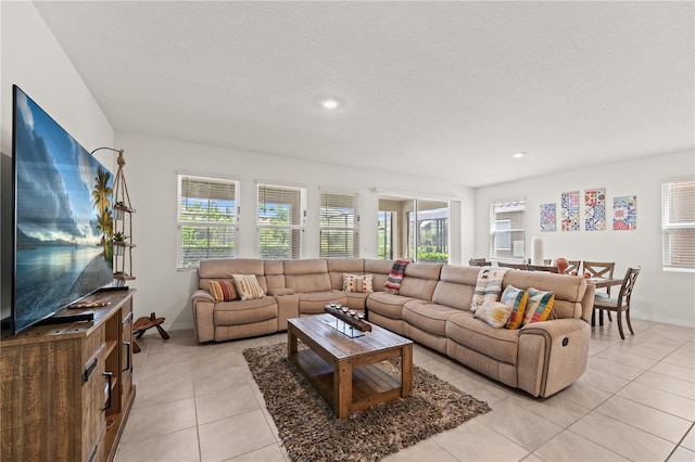 living area featuring baseboards, a wealth of natural light, recessed lighting, and light tile patterned floors