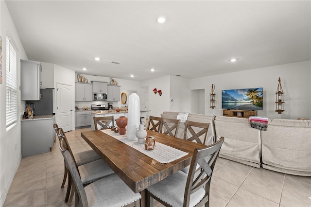 dining space featuring baseboards, recessed lighting, and light tile patterned floors