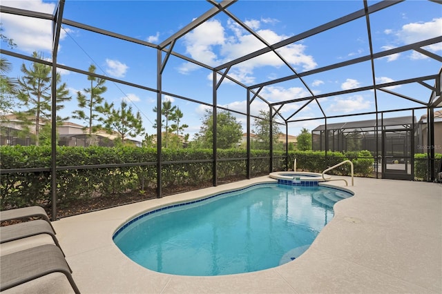view of swimming pool with a patio area, glass enclosure, and a pool with connected hot tub