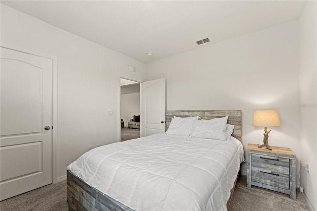 carpeted bedroom with baseboards and visible vents