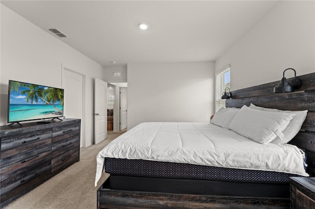 bedroom featuring light carpet and visible vents