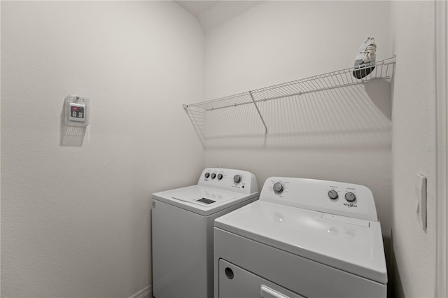 washroom featuring washing machine and clothes dryer and laundry area