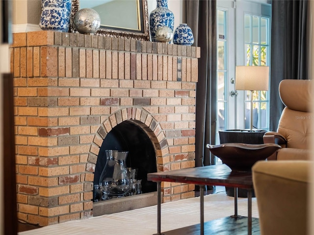 living area with a brick fireplace