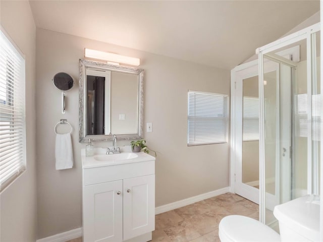 bathroom featuring baseboards, toilet, lofted ceiling, tile patterned floors, and vanity