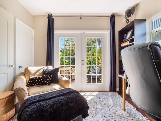 bedroom with access to outside, french doors, and wood finished floors