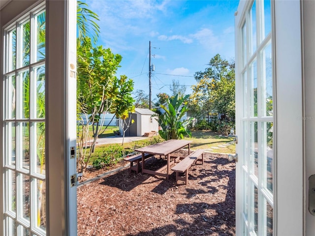 view of yard featuring a shed and an outdoor structure