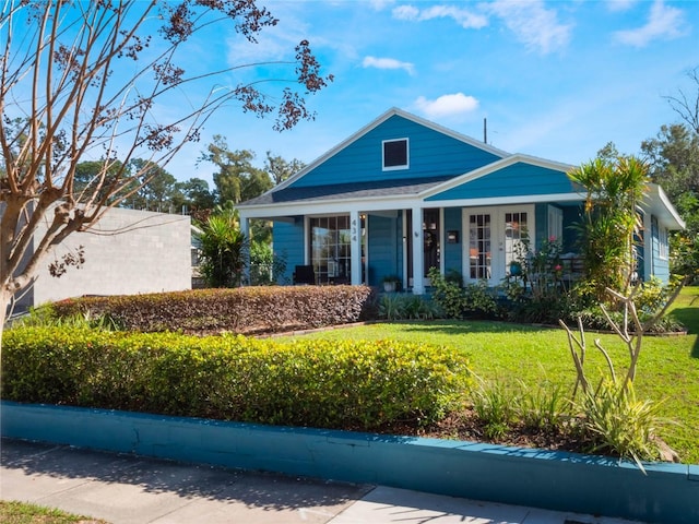 view of front of house with a porch and a front yard