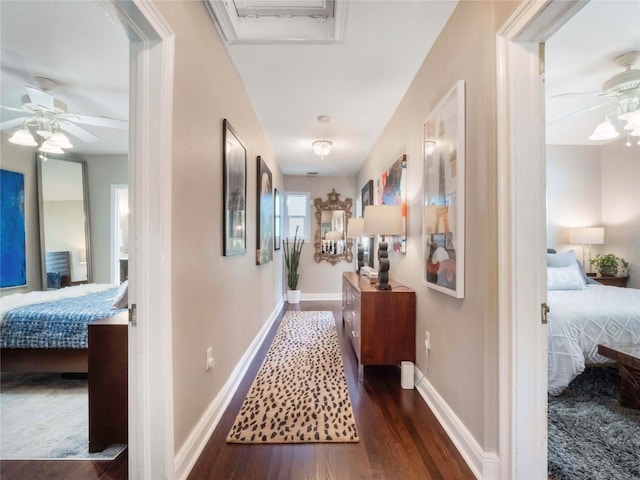 hall featuring baseboards and wood finished floors