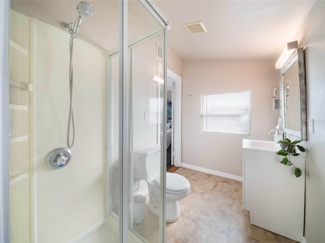 bathroom with visible vents, toilet, a shower stall, vanity, and baseboards