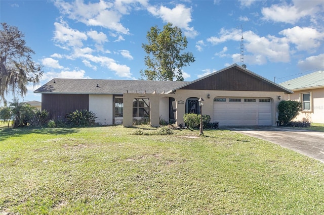 single story home featuring an attached garage, a front lawn, and concrete driveway