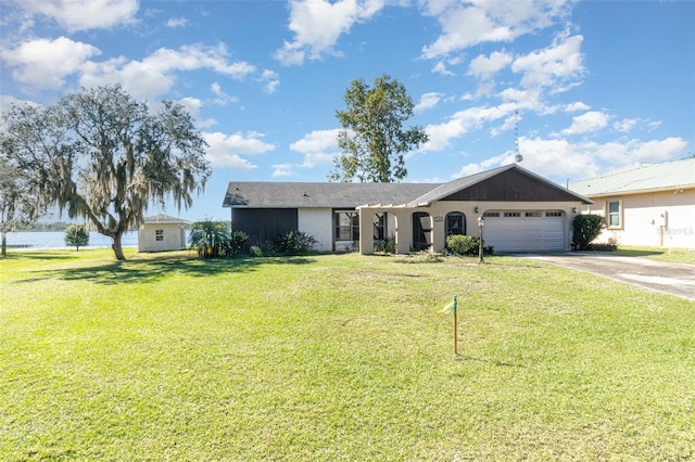 ranch-style house with a garage, a front yard, and driveway