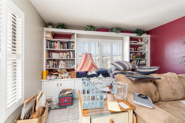 misc room featuring a textured ceiling and light tile patterned floors