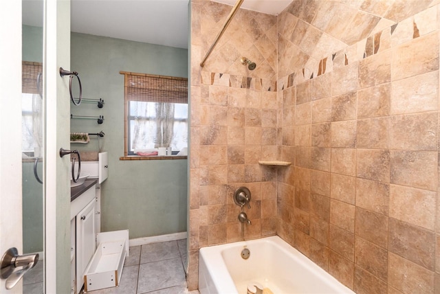 full bath with tile patterned flooring, vanity, baseboards, and shower / bathtub combination