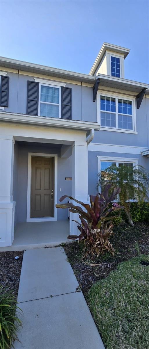 doorway to property with stucco siding