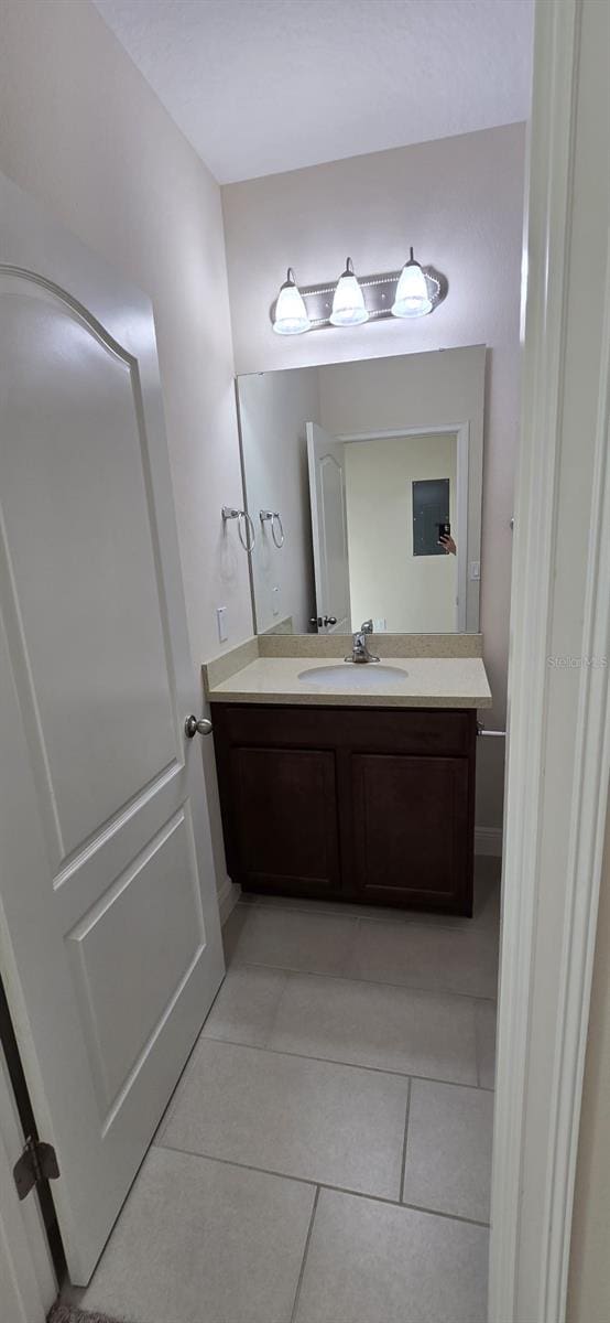 bathroom featuring tile patterned flooring, baseboards, and vanity