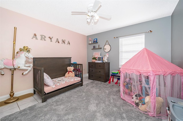 tiled bedroom with baseboards and ceiling fan