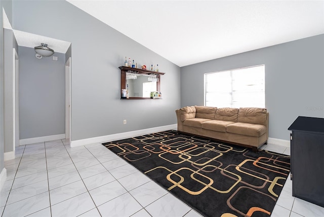 living room with baseboards and vaulted ceiling