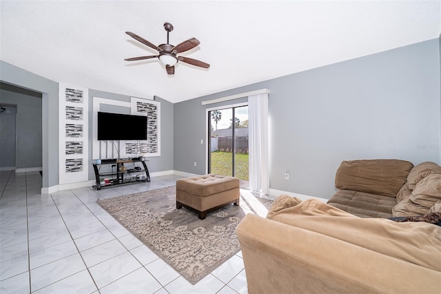 living area featuring lofted ceiling, baseboards, and ceiling fan