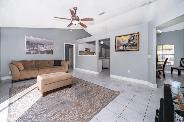 living room with visible vents, ceiling fan, baseboards, and lofted ceiling