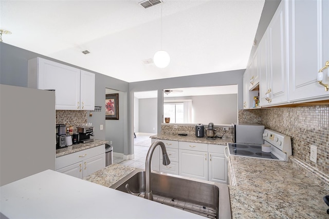 kitchen featuring white appliances, light countertops, lofted ceiling, and a sink