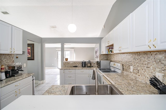 kitchen featuring white electric stove, visible vents, light countertops, and a sink