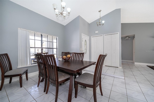 dining area with high vaulted ceiling, baseboards, marble finish floor, and a chandelier