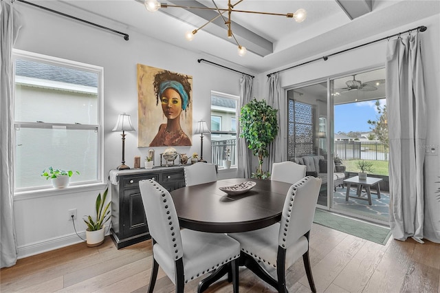 dining space with baseboards and light wood finished floors