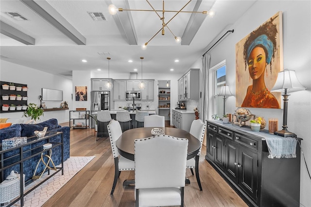 dining area with recessed lighting, visible vents, beamed ceiling, and light wood finished floors