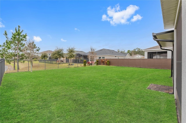 view of yard with a fenced backyard and a residential view