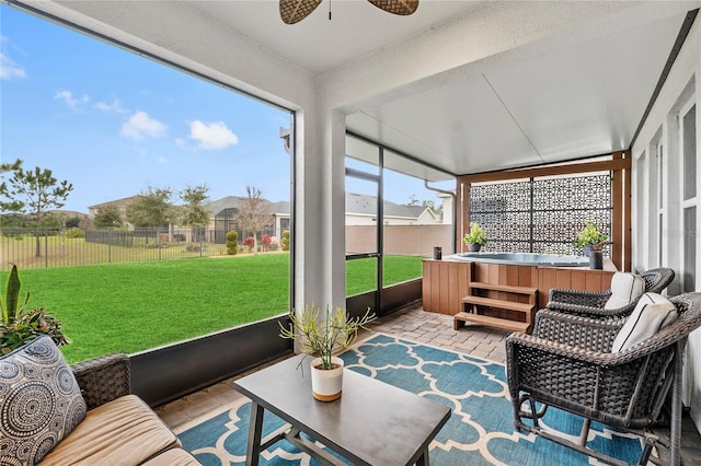 sunroom featuring ceiling fan