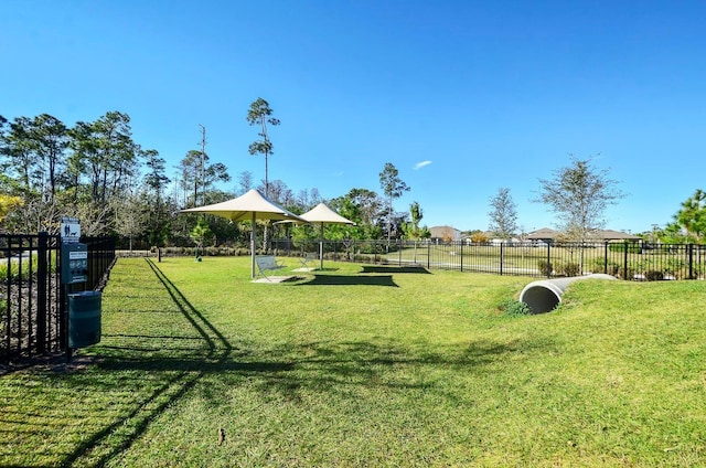 view of property's community featuring fence and a lawn