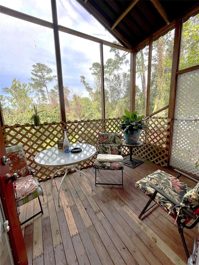 unfurnished sunroom with vaulted ceiling