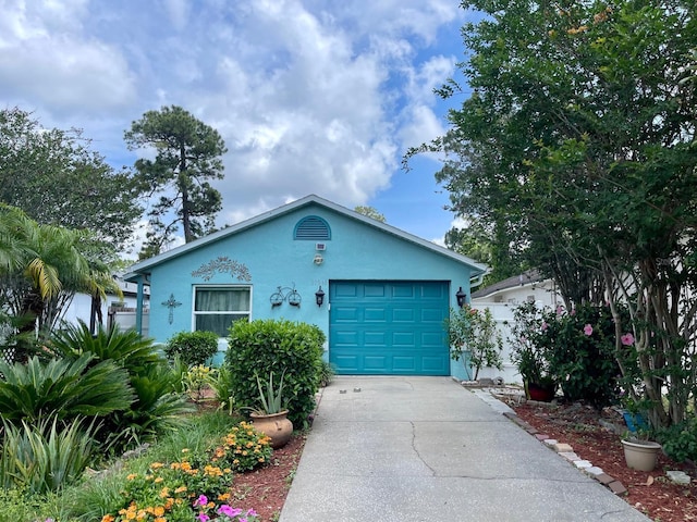 11213 River Grove Dr, Orlando, FL 32817 - view of front facade with stucco siding, concrete driveway, and a garage