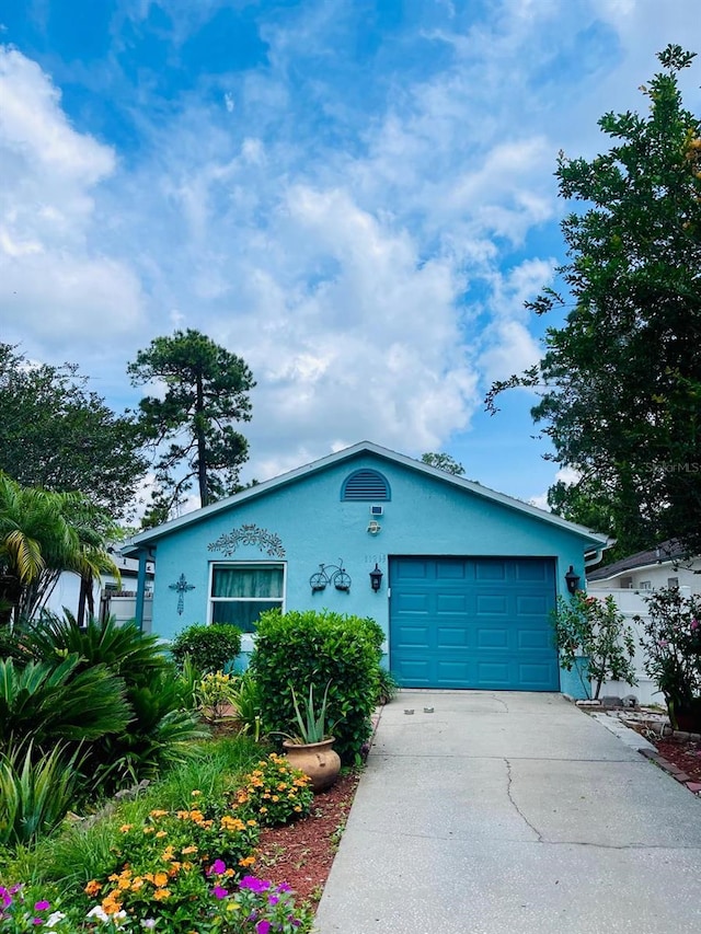 11213 River Grove Dr, Orlando, FL 32817 - ranch-style home with stucco siding, driveway, and a garage