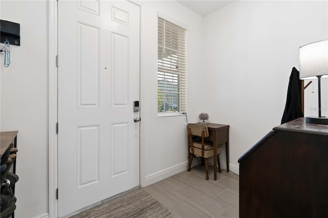 foyer featuring baseboards