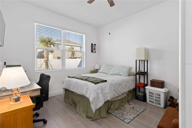 bedroom with tile patterned flooring, ceiling fan, and baseboards