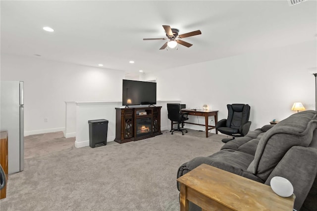 living room with light carpet, baseboards, a ceiling fan, and recessed lighting