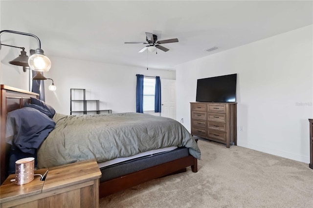 bedroom featuring light carpet, ceiling fan, visible vents, and baseboards