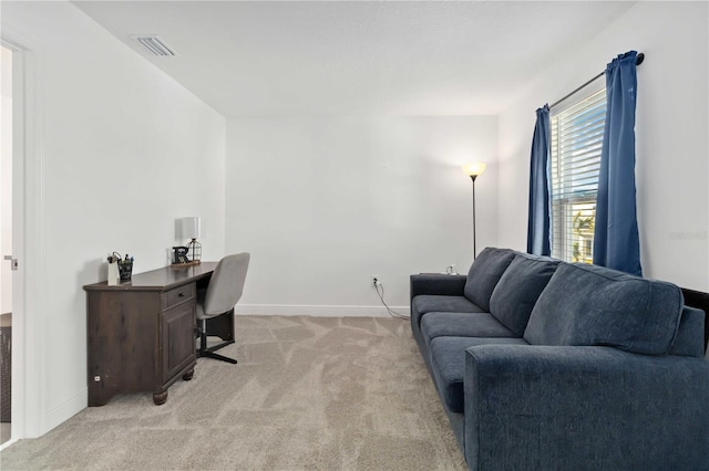 office area with light carpet, visible vents, and baseboards