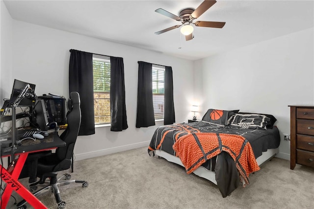 carpeted bedroom featuring a ceiling fan and baseboards