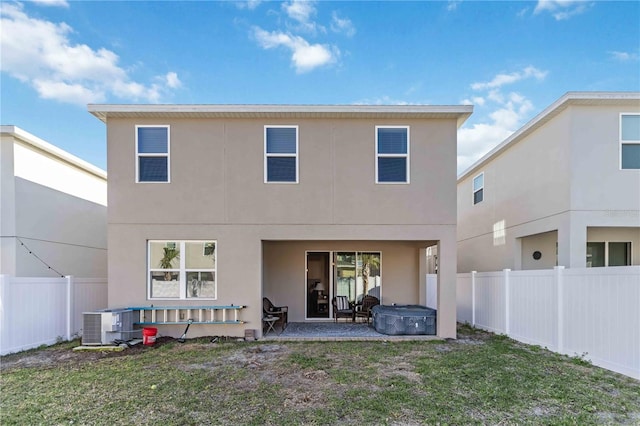 back of property featuring a patio area, a lawn, a fenced backyard, and central air condition unit